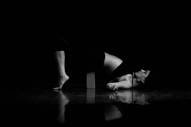 istock Yoga poses at black background monochrome 1181897509