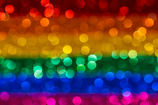 Close up photo of rainbow flag with bokeh light effect, LGBT movement concept