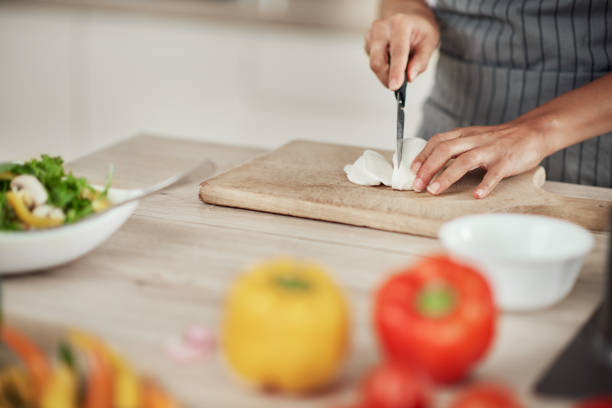 istock Woman cutting mushrooms. 1181899998