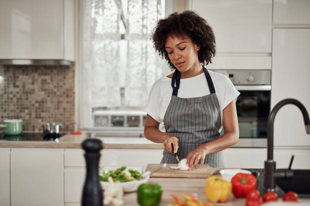istock Woman chopping mushrooms. 1181900048