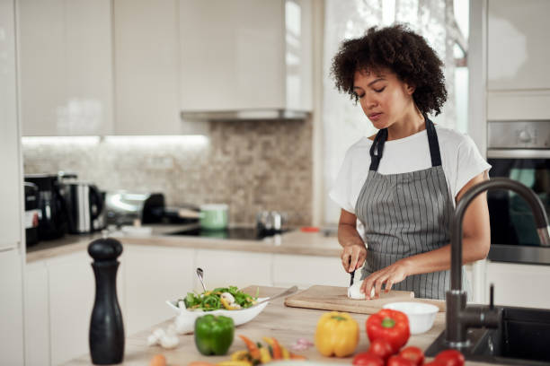 istock Woman chopping mushrooms. 1181900157