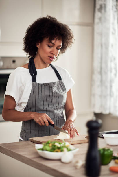 istock Woman chopping mushrooms. 1181900209