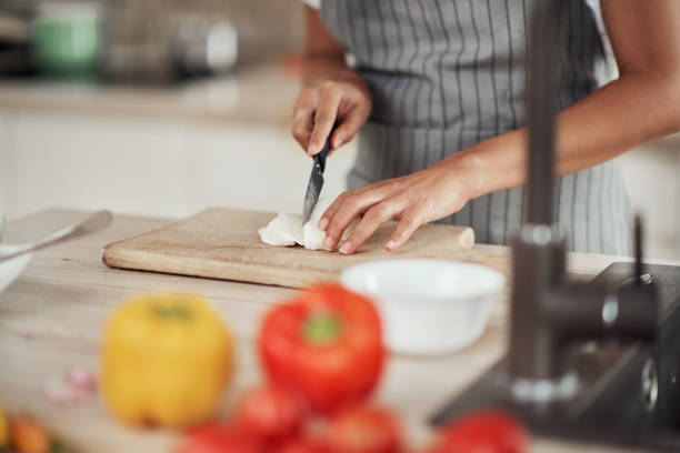 istock Woman cutting mushrooms. 1181900307