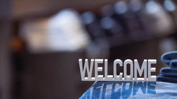 White welcome sign on dark background stock photo