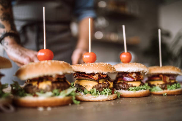 istock Homemade cheeseburgers in a row on table 1181902626