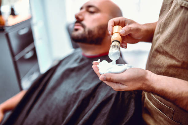 istock Barber Preparing The Shaving Foam For Customer 1181904371