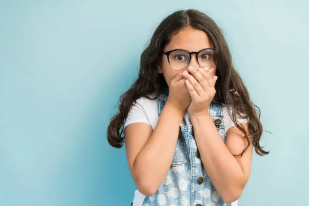 Photo of Portrait Of Surprised Latin Female Child In Studio