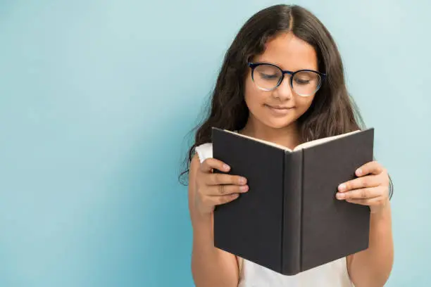 Photo of Cute Girl Studying Against Plain Background