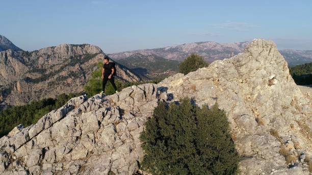 istock Man Traveler with big backpack mountaineering 1181906243