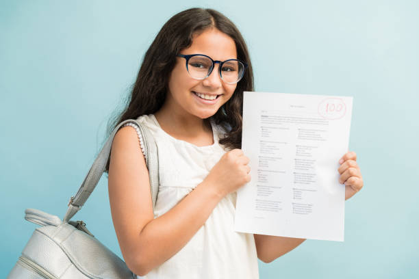 istock Hispanic Female Student Holding Exam Paper 1181906776