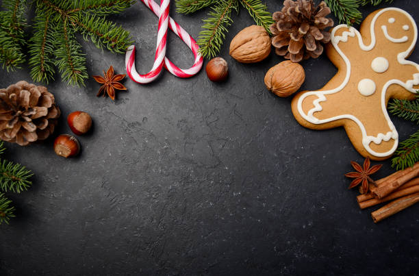 Christmas background with Fir Branches, Cones, Spices and Gingerbread. Christmas background with Fir Branches, Cones, Spices and Gingerbread. Top view, horizontal with copy space. walnut cookies stock pictures, royalty-free photos & images