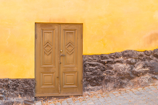 old wooden Door with yellow wall