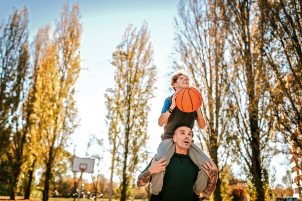 on my dad's shoulders where i get the best view - tattoo father family son imagens e fotografias de stock