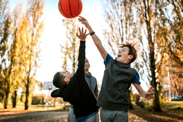 rivalidad entre hermanos en el partido de baloncesto - ball horizontal outdoors childhood fotografías e imágenes de stock