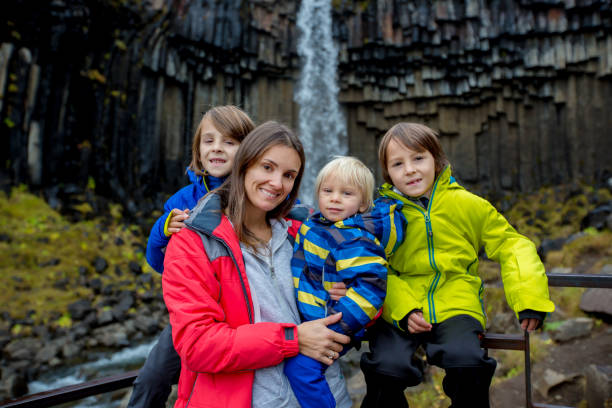 快樂的孩子們，在冰島斯卡夫塔費爾國家公園美麗的瀑布前擺姿勢 - skaftafell national park 個照片及圖片檔