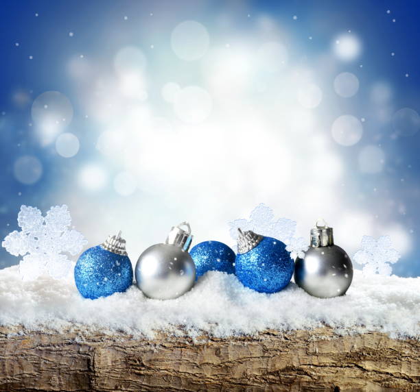 istock Winter background with snow and blur abstract lights. Empty wooden plank. Copyspace for text. 1181909294
