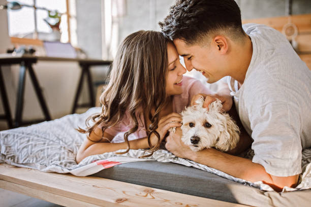 istock Loving Couple in bed with their pet dog 1181912021