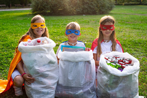 istock Portrait three kids cleaning public park 1181912213