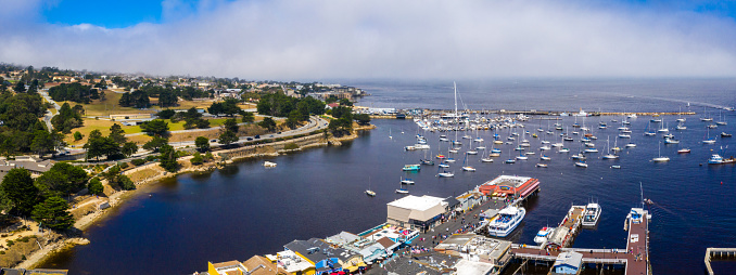 Aerial view of the Monterey town in California near Monterey Bay Aquarium with many yachts by the Pacific ocean.