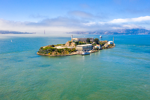 Beautiful aerial view of the Alcatraz island with Golden Gate bridge on the background in San Francisco, USA.