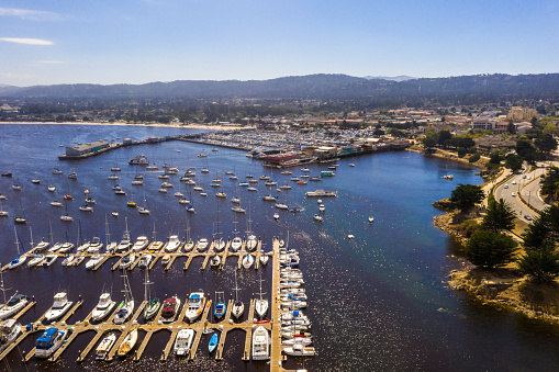 Aerial view of the Monterey town in California near Monterey Bay Aquarium with many yachts by the Pacific ocean.