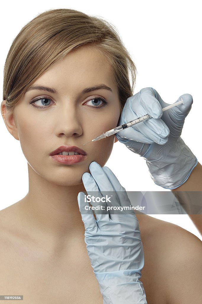 Botox injection Young woman getting a Botox injection - lips.  Adult Stock Photo