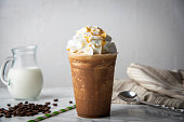 caramel frappuccino with wipped cream on marble table
