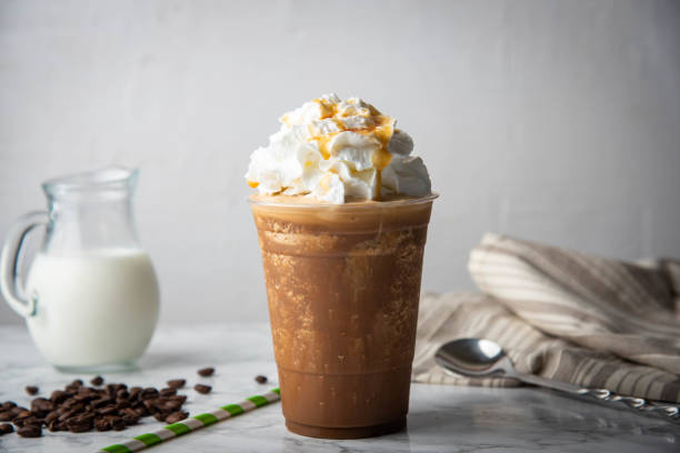 caramel frappuccino with wipped cream on marble table caramel frappuccino with wipped cream on marble table milkshake stock pictures, royalty-free photos & images
