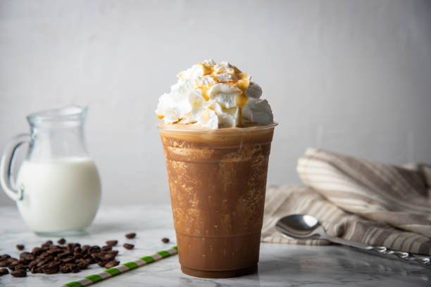 caramel frappuccino with wipped cream on marble table - wipped cream imagens e fotografias de stock