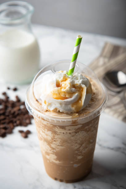 caramel frappuccino with wipped cream on marble table - wipped cream imagens e fotografias de stock