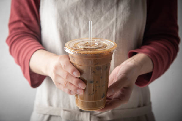 istock barista serving iced coffee in plastic cup 1181926822