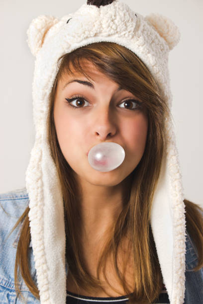 istock Woman blowing chewing bubble gum 1181926910