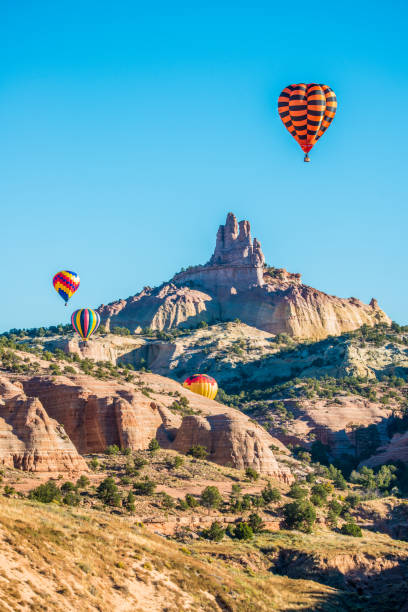 Flying Over Castle Rock Hot air balloons flying over Castle Rock in Red rock Canyon State Park near Gallup, New Mexico. Castle Rock stock pictures, royalty-free photos & images