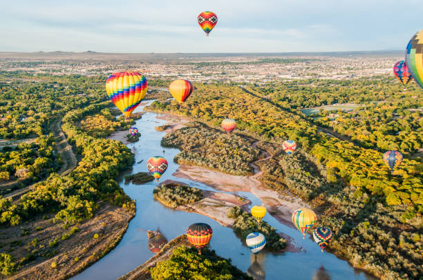 Balloons over The Rio Grande Hot air balloons floating over the Rio Grande near Albuquerque, New Mexico. new mexico stock pictures, royalty-free photos & images