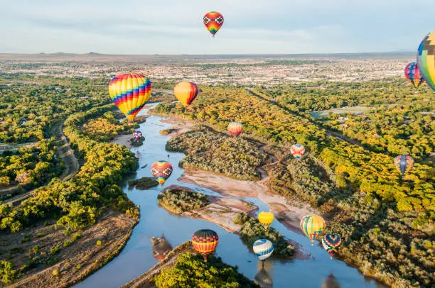 Hot air balloons floating over the Rio Grande near Albuquerque, New Mexico.