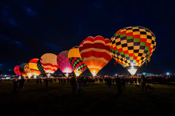 Hot air balloons launching for flight in the dark before sunrise in Albuquerque, New Mexico.