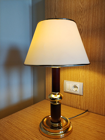 Bedside electric lamp with electric outlet