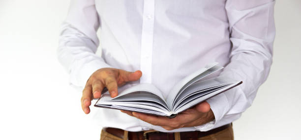 istock A man holds in his hands a notebook, notebook, diary and pen. Business concept isolated on white background. 1181928294