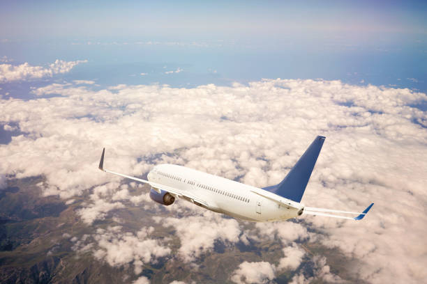 istock Passenger jet airplane flying above clouds stock 1181929461