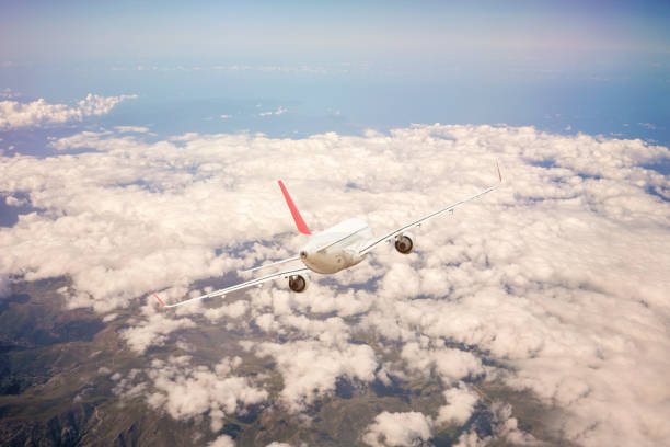 istock Passenger jet airplane flying above clouds stock 1181929466