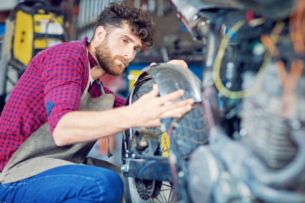 istock Man is working on a custom made motorbike 1181930541