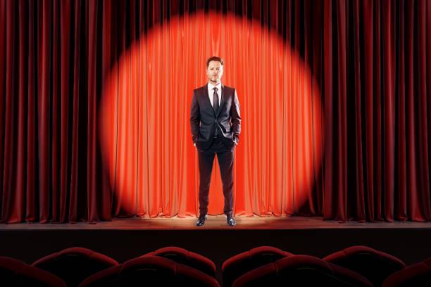 istock Attractive businessman on red stage 1181933458