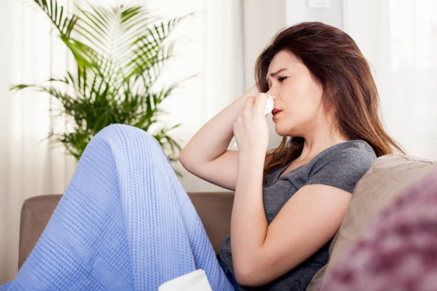 istock young woman got flu and sitting on sofa 1181934363