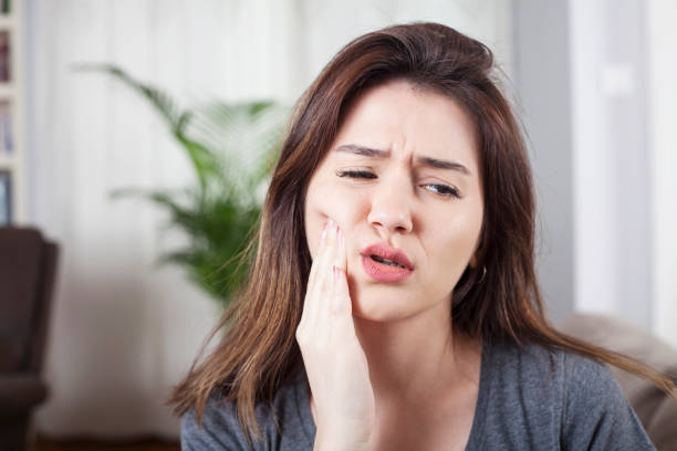 istock young woman have toothache 1181934602