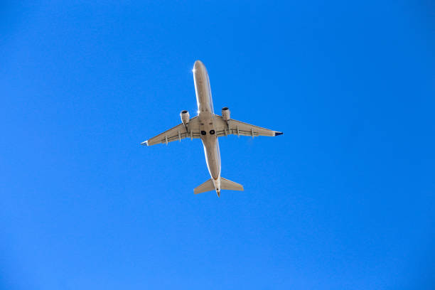 istock Plane furrowing the blue sky. 1181937720