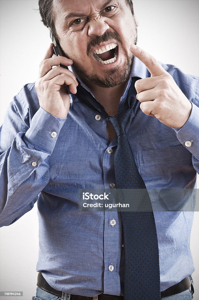 aggressive man shouting at telephone. Aggression Stock Photo