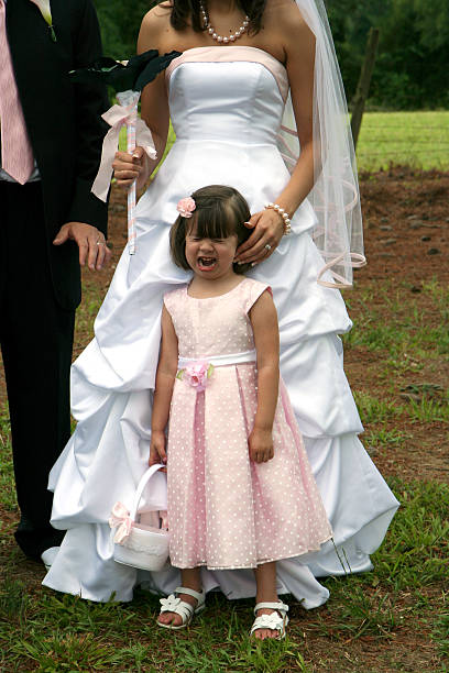 Flower girl crying Flower girl crying during wedding photos. flower girl stock pictures, royalty-free photos & images