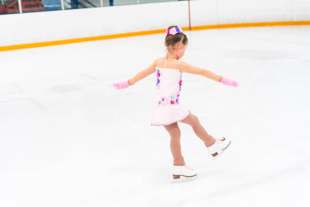 istock Little girl practicing figure skating moves 1181944597