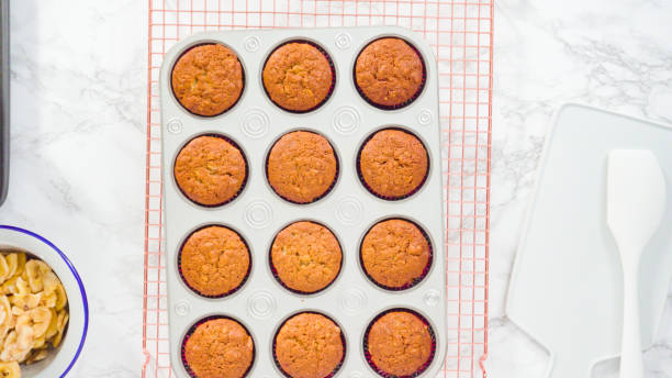 istock Garnishing banana bread muffins 1181944642