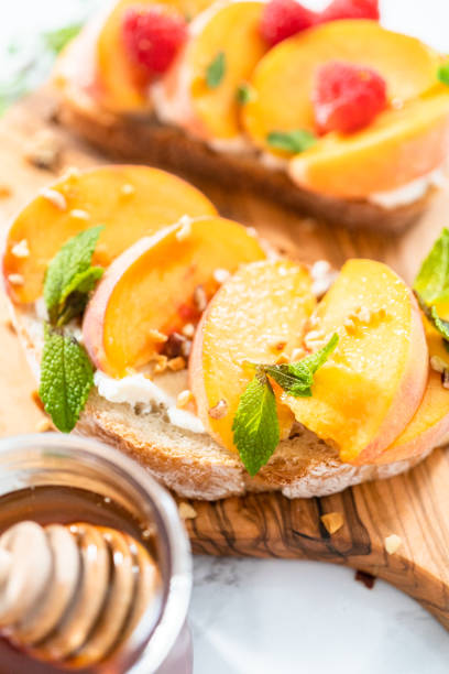 istock Peach ricotta toasts garnished with walnuts, fresh mint 1181944704